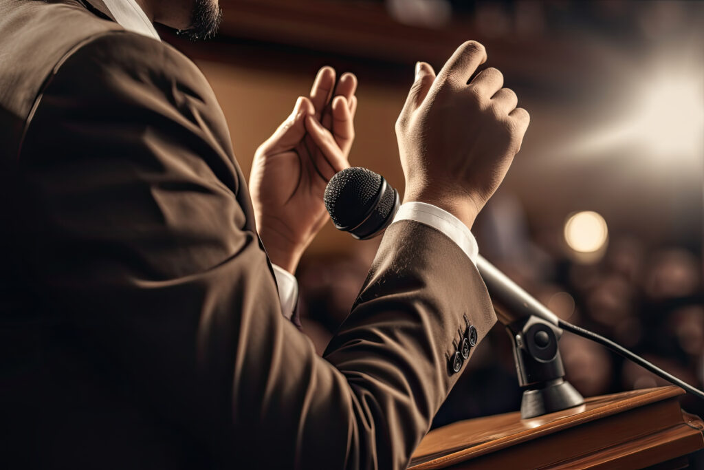 Back view of public speaker giving talk in conference hall at business event. Person makes speech in front of public. Created with Generative AI